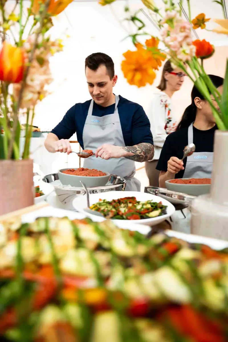 Küchenteam in edison Schürze richtet Salate am Buffet des Kultursalon an